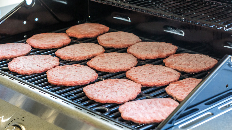 Frozen burgers cooking on the grill