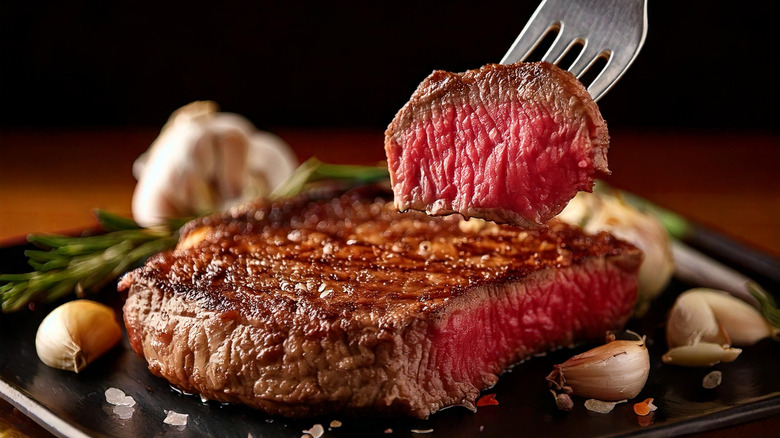 Close up of a piece of steak cooked medium-rare, cut open