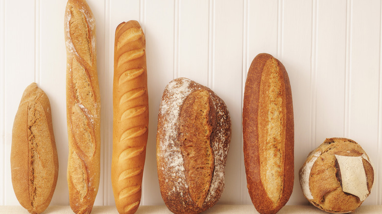 Various loaves of bread on white wall
