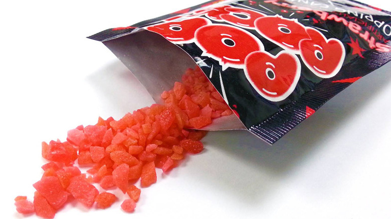 Red Pop Rocks candy spilling out of pouch