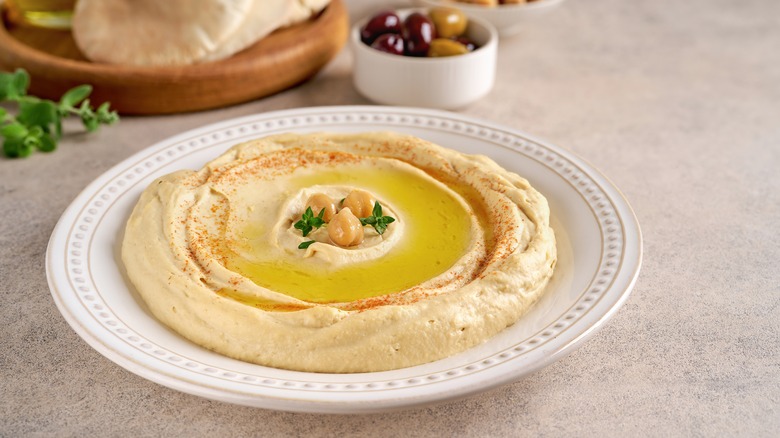 A bowl of hummus with oil