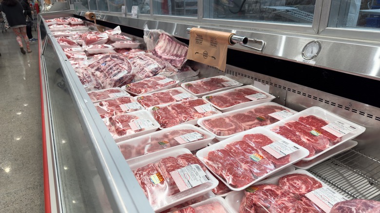 A Costco butcher chest full of different steaks and meats