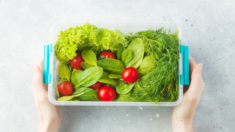 salad with cherry tomatoes in a plastic container 