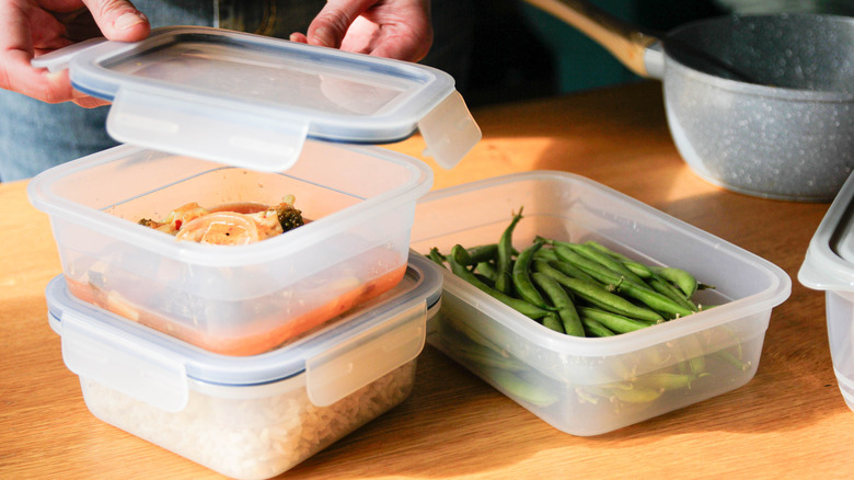 Person packages food in storage containers