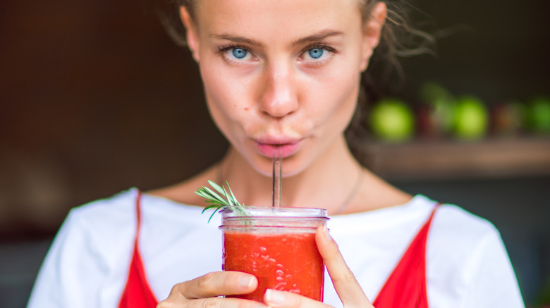 Girl drinking tomato juice 