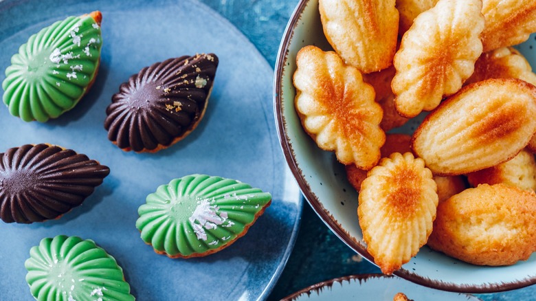 Bowl of festive madeleines dipped in green icing and chocolate icing