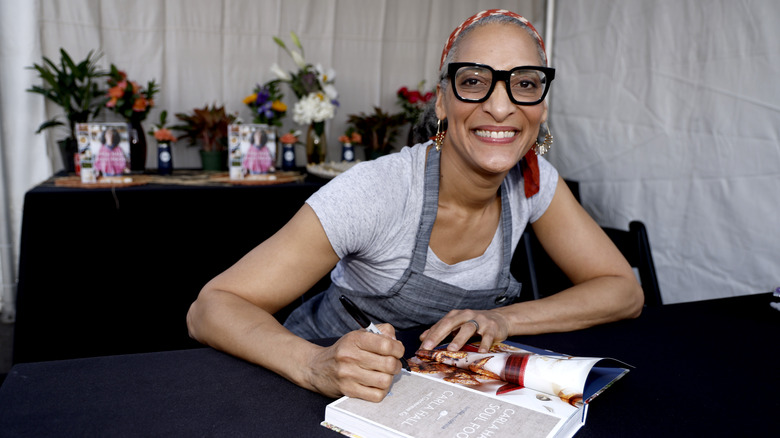 Carla Hall signing copies of her cookbook