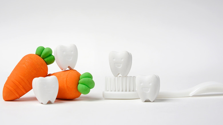 clay carrots, teeth, and toothbrush