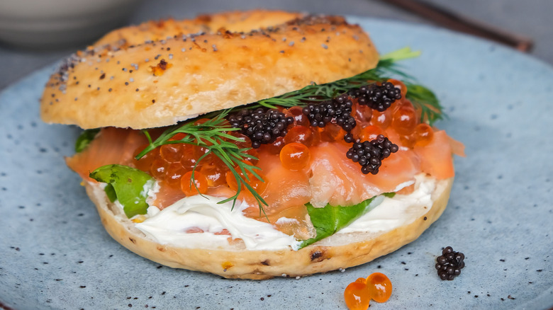 Caviar on bagel with lox, roe, and greens