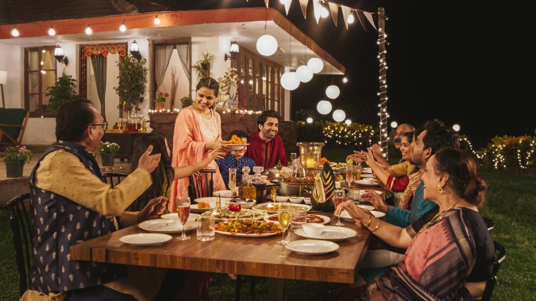 Family around dining table celebrating Diwali