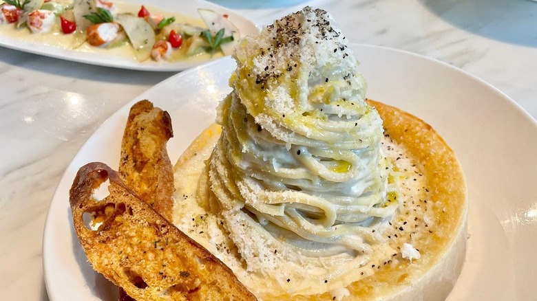 Pasta on a cheese wheel dish