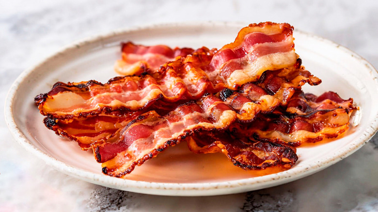 strips of bacon on a white plate