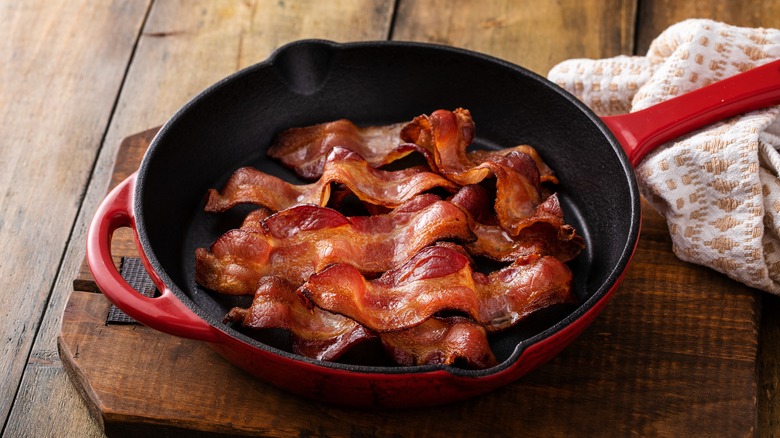 bacon in a red frying pan