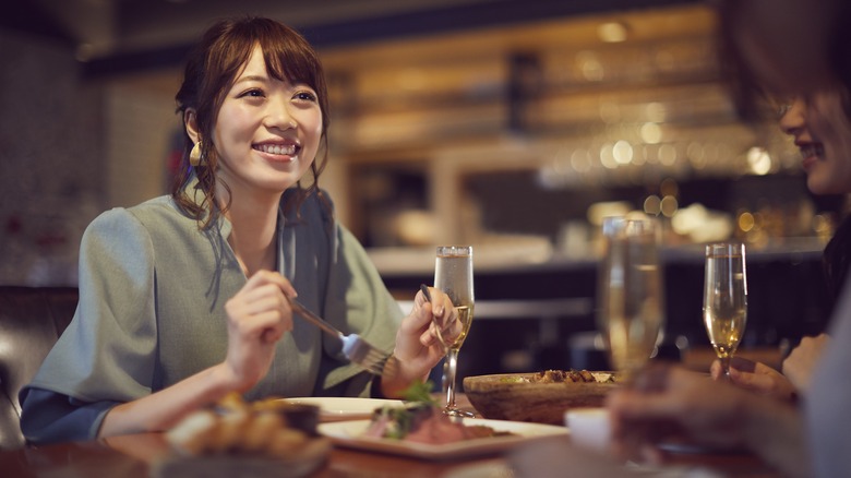 Woman smiling at upscale restaurant