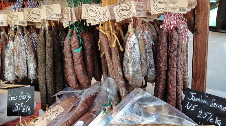 Dried sausages in charcuterie shop