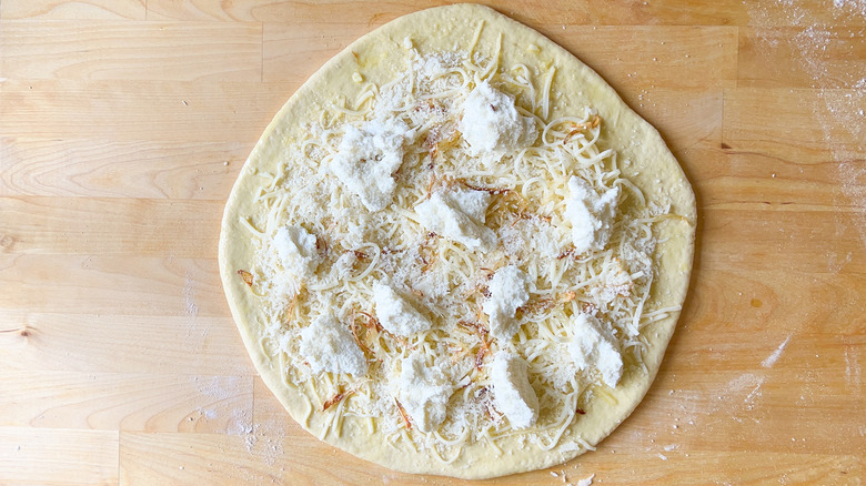 pizza dough with cheese toppings
