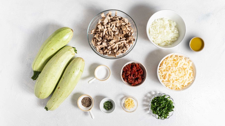 Ingredients for a Cheesy Mushroom Zucchini Boats recipe.