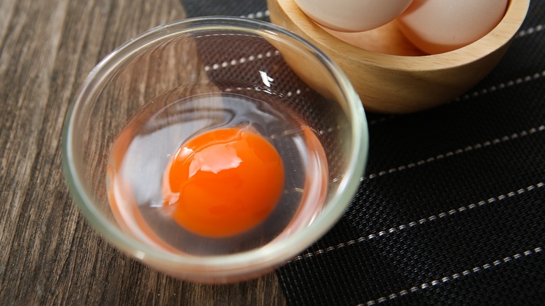 Duck egg cracked in bowl 