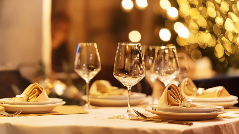 Dinner table setting with wine glasses