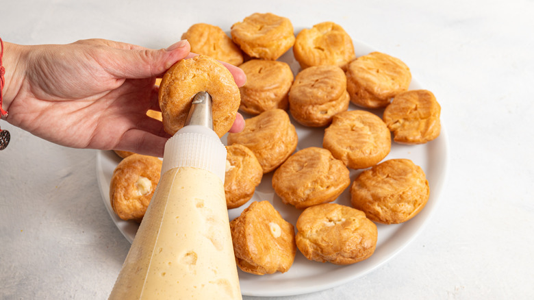 filling pastry dough with cream