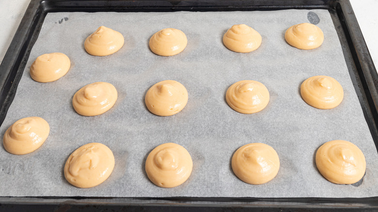 piped pastry dough on tray