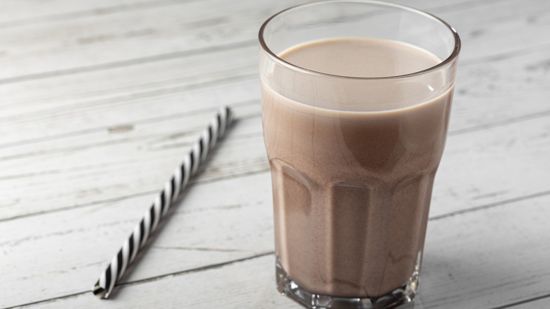 Glass of chocolate milk with straw