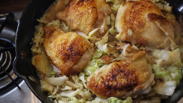pan of cabbage and chicken thighs