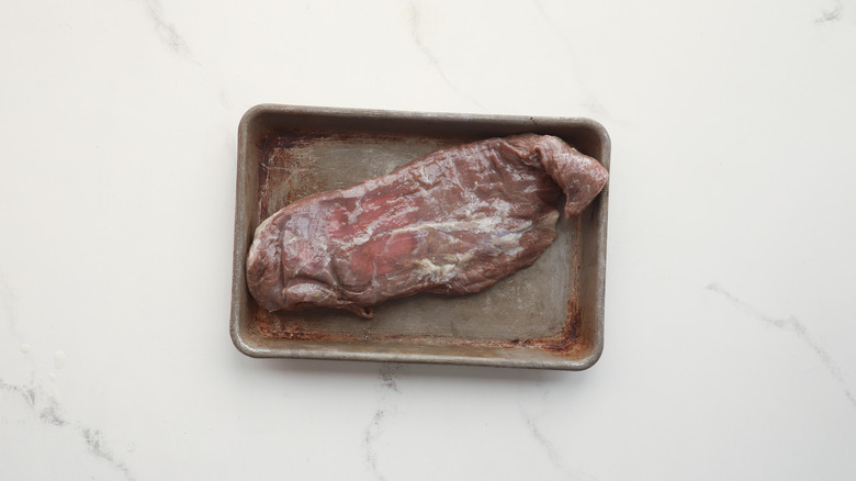 Marinated flank steak on tray