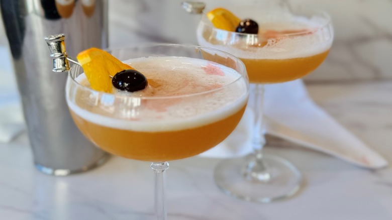 orange cocktail with fruit garnish