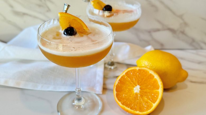 orange cocktail with fruit garnish