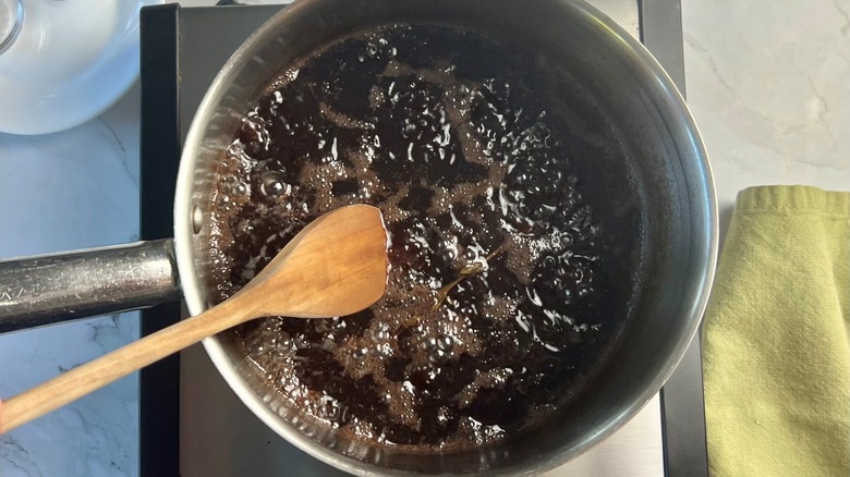 beef jus simmering in saucepan