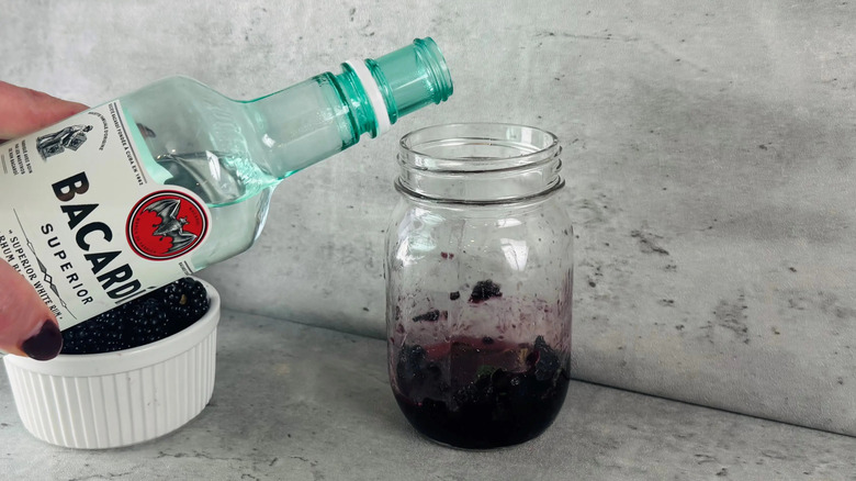 Bacardi white rum pouring into glass jar