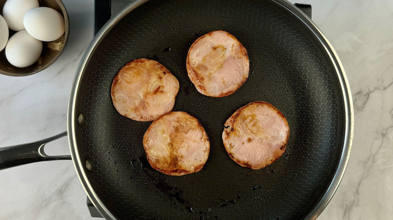 browned bacon slices in pan