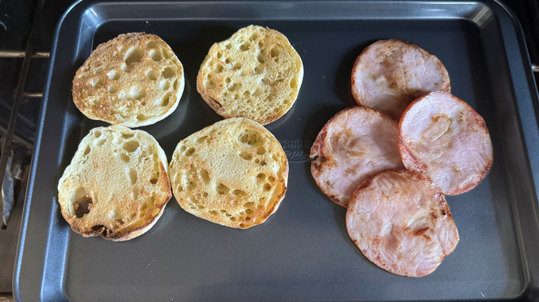english muffins and bacon on sheet