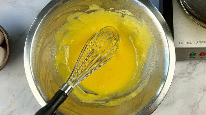 whisking butter into sauce