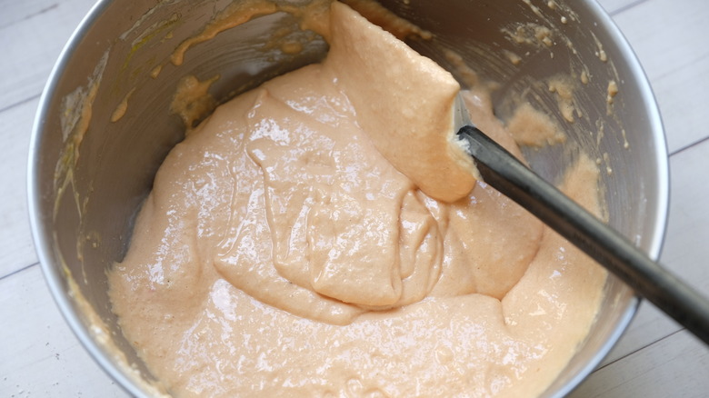 orange macarons batter in bowl