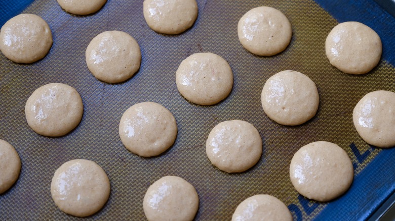 macarons shells on baking sheet