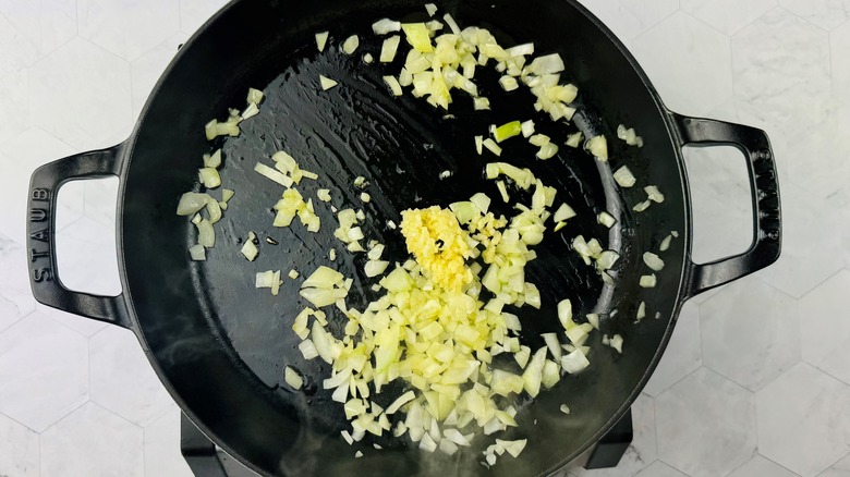 sauteeing diced onions and minced garlic in skillet