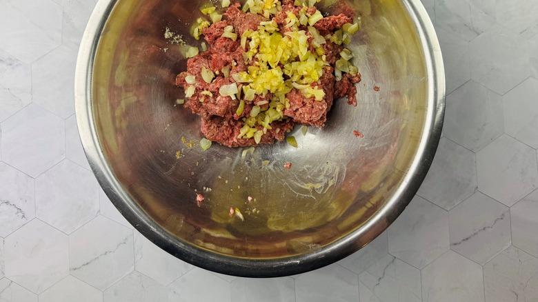 ground beef mixture with sauteed alliums in bowl