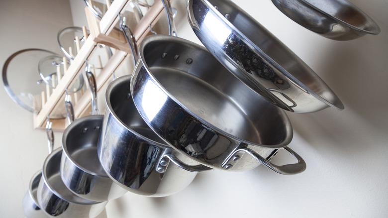 Stainless steel pots hanging on wall