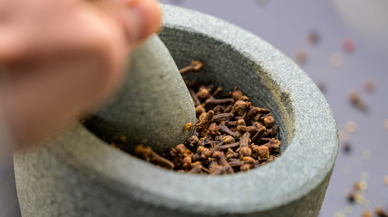 spices being crushed by mortar and pestle