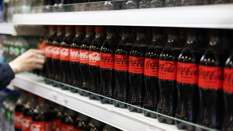 Coca-Cola bottles on store shelf