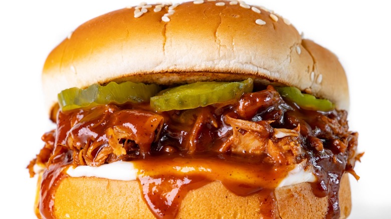 Pulled pork sandwich with pickles and barbecue sauce