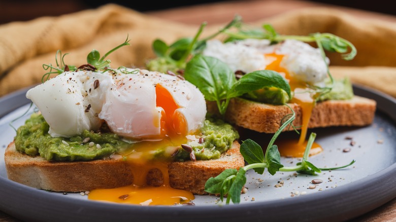 Poached eggs on top of avocado toast