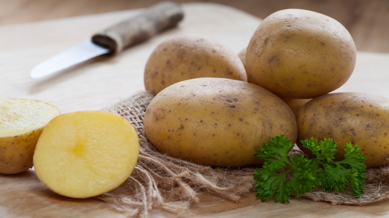 Sliced potato and whole potatoes