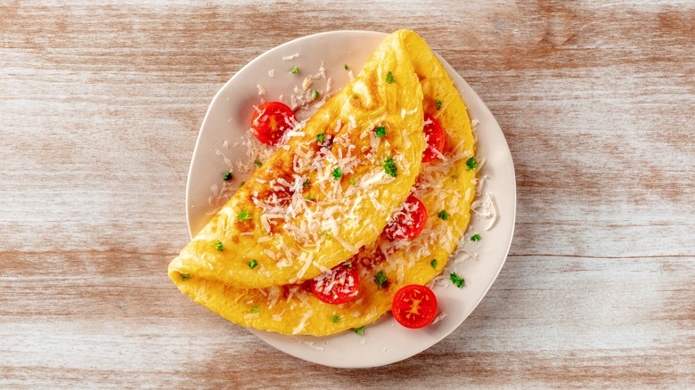 Tomato omelet on white plate