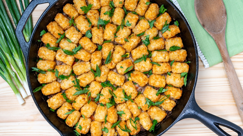 Tater tot casserole in a cast iron skillet