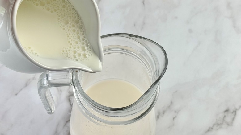 pouring milk into pitcher