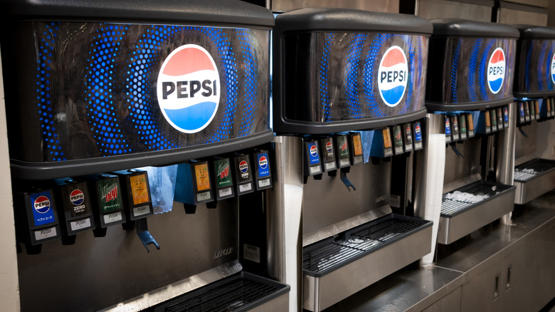 A line of Costco food court soda fountains adorned with Pepsi logo and products