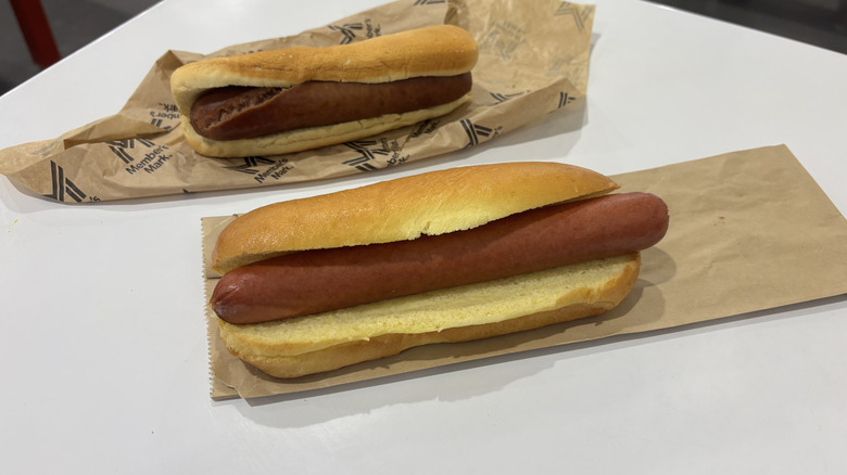 Both hot dogs undressed on table